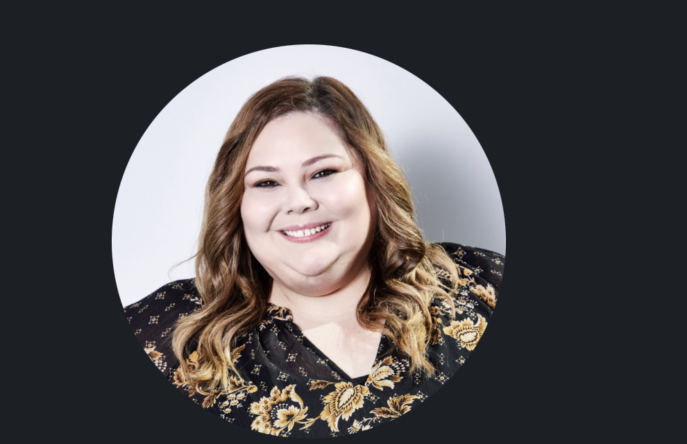 Jillian King, smiling, in a black and gold floral top